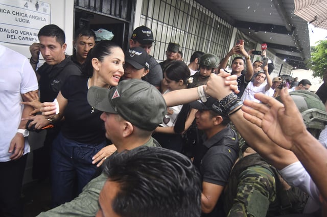 Luisa Gonzalez, presidential candidate from the Citizen Revolution party, greets supporters after voting in the presidential election runoff in Canuto, Ecuador, Sunday, April 13, 2025. (AP Photo/Ariel Ochoa)