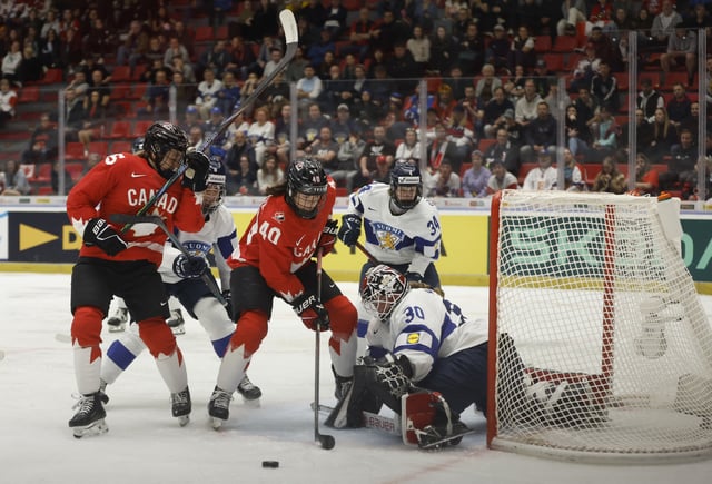 Ice Hockey - IIHF Women's World Championships - Semi Final - Canada v Finland - Budvar Arena, Ceske Budejovice, Czech Republic - April 19, 2025 Finland's Emilia Kyrkko in action with Canada's Blayre Turnbull REUTERS/David W Cerny