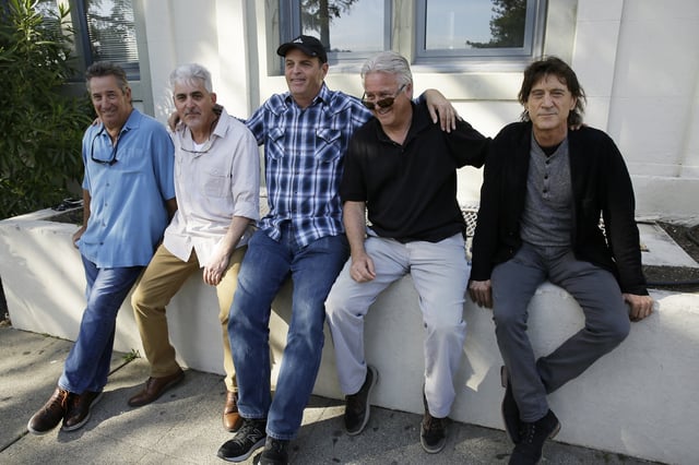 FILE - In this Friday, April 13, 2018, photo, the Waldos, from left, Mark Gravitch, Larry Schwartz, Dave Reddix, Jeffrey Noel and Steve Capper sit on a wall they used to frequent at San Rafael High School in San Rafael, Calif. Friday is April 20, or 4/20. (AP Photo/Eric Risberg, File)
