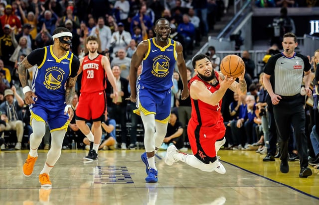 Rockets guard Fred VanVleet falls and throws up a shot on a foul by the Warriors’ Draymond Green to end the first half of their game at Chase Center on April 6.