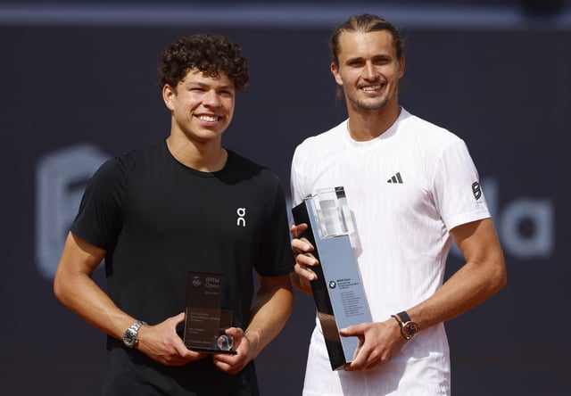 Tennis - ATP 500 - Munich Open - MTTC Iphitos, Munich, Germany - April 20, 2025 Germany's Alexander Zverev celebrates with the trophy after winning the Munich Open alongside runner-up Ben Shelton of the U.S. REUTERS/Michaela Stache