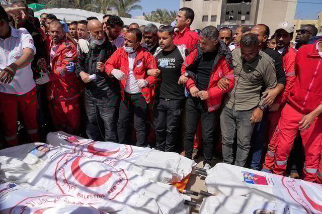 Mourners gather around the bodies of 8 Red Crescent emergency responders recovered in Rafah a week after an Israeli attack.