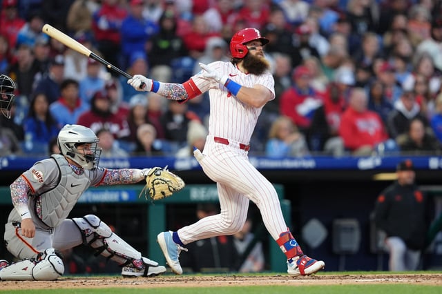 Apr 15, 2025; Philadelphia, Pennsylvania, USA; Philadelphia Phillies outfielder Brandon Marsh (16) hits a sacrifice fly against the San Francisco Giants in the second inning at Citizens Bank Park. All players wore #42 for Jackie Robinson Day. Mandatory Credit: Kyle Ross-Imagn Images/File Photo