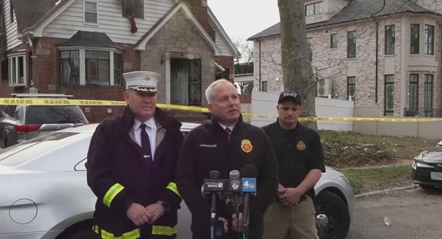 FDNY officials in front of a home where three people died in a blaze.
