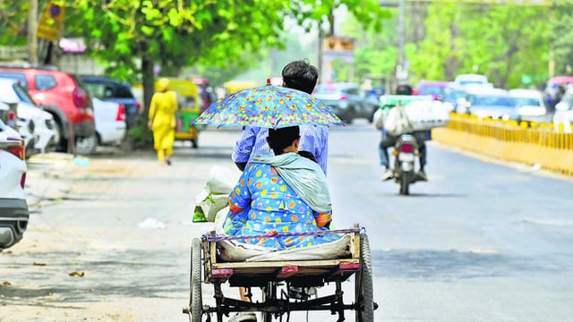 A woman covers her head to escape the heat amid the rising temperature in Delhi-NCR. (Sunil Ghosh/HT photo)