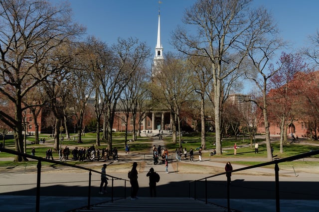 People cross the Harvard Yard at Harvard University on April 17, 2025 in Cambridge, Massachusetts.