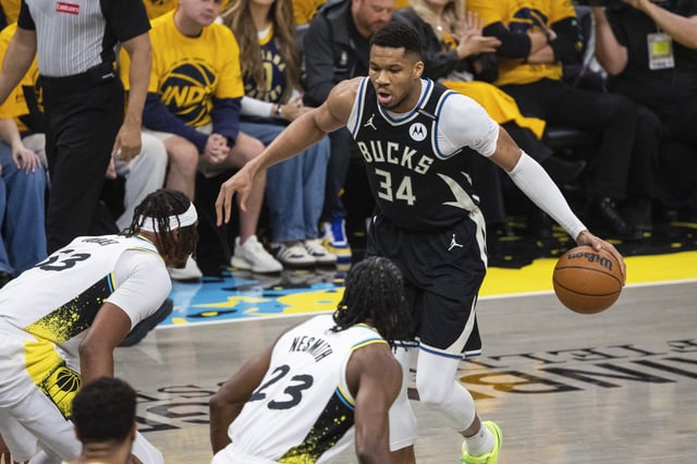 Apr 19, 2025; Indianapolis, Indiana, USA;  Milwaukee Bucks forward Giannis Antetokounmpo (34) dribbles the ball while Indiana Pacers center Myles Turner (33) defends in the first half at Gainbridge Fieldhouse. Mandatory Credit: Trevor Ruszkowski-Imagn Images