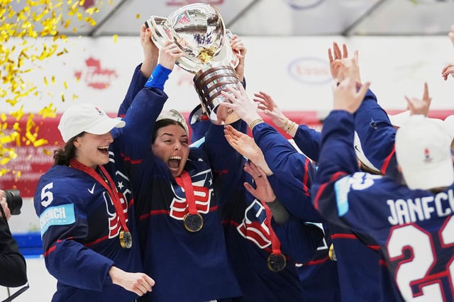 United states players celebrate with a trophy after the gold medal match between Canada and United States at the Women's Ice Hockey Championships in Ceske Budejovice, Czech Republic, on Sunday, April 20, 2025.