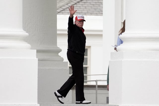 U.S. President Donald Trump gestures while wearing a hat that reads "Gulf of America", as he returns to the White House, in Washington, D.C., U.S., April 20, 2025. REUTERS/Ken Cedeno