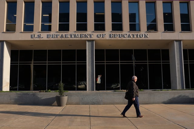 A person walks past the U.S. Department of Education on March 20, 2025 in Washington, DC.