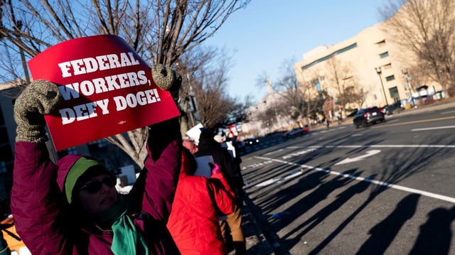 Protesters against federal job cuts outside a D.C. office building. Photo: Stefani Reynolds/Bloomberg via Getty Images
