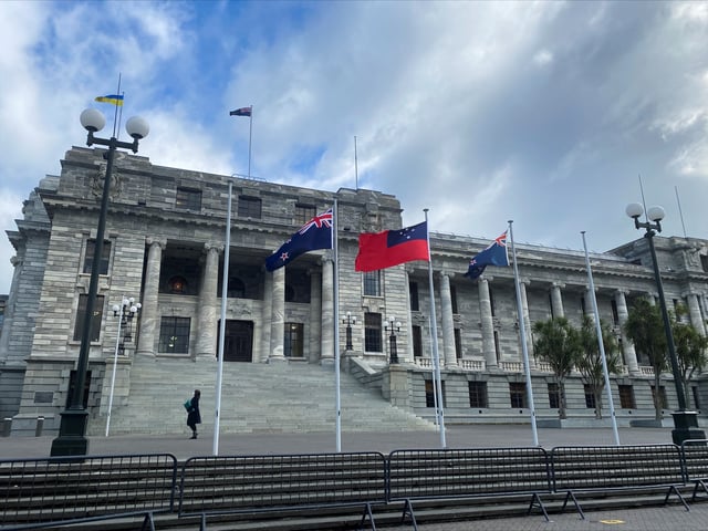 A pedestrian walks past the New Zealand Parliament Buildings in Wellington, New Zealand, June 14, 2022. REUTERS/Lucy Craymer