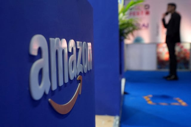 A visitior stands near a logo of Amazon during the annual Retail Leadership Summit in Mumbai, India, February 27, 2025. REUTERS/Hemanshi Kamani/File Photo