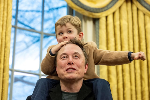 Elon Musk carries his son X Æ A-Xii on his shoulders while speaking in the Oval Office of the White House in Washington, DC, on February 11, 2025.