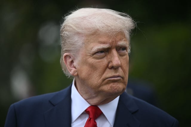 US President Donald Trump looks on as he hosts the annual Easter Egg Roll on the South Lawn of the White House on April 21, 2025, in Washington, DC. According to the US National Park Service, the egg roll tradition dates back to 1878 when President Rutherford B. Hayes invited children to roll Easter eggs on the White House grounds. Children previously rolled eggs down a hill at the US Capitol in the early 1870s, but a law was passed in 1876 forbidding the Capitol property from being used due to the toll on the lawn. (Photo by Brendan SMIALOWSKI / AFP) (Photo by BRENDAN SMIALOWSKI/AFP via Getty Images)          
