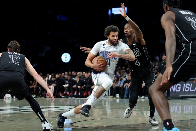 Apr 7, 2023; Brooklyn, New York, USA; Orlando Magic guard Michael Carter-Williams (11) drives to the basket against Brooklyn Nets guard Edmond Sumner (4) and forward Joe Harris (12) and center Day'Ron Sharpe (20) during the first quarter at Barclays Center. Mandatory Credit: Brad Penner-USA TODAY Sports/File Photo