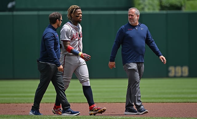 PITTSBURGH, PENNSYLVANIA - MAY 26: Ronald Acuña Jr. #13 of the Atlanta Braves walks off the field with trainers after an apparent injury in the first inning during the game against the Pittsburgh Pirates at PNC Park on May 26, 2024 in Pittsburgh, Pennsylvania.
