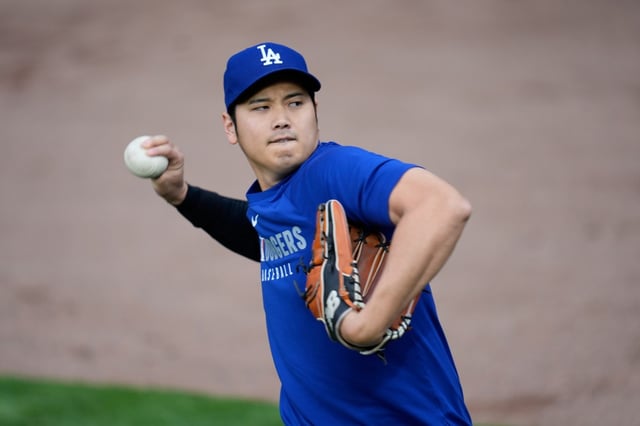 Dodgers star Shohei Ohtani throws in the outfield before their game against the Chicago Cubs on Tuesday at Wrigley Field in Chicago. There is still no firm target for when the two-way star might pitch this season. (AP Photo/Erin Hooley)