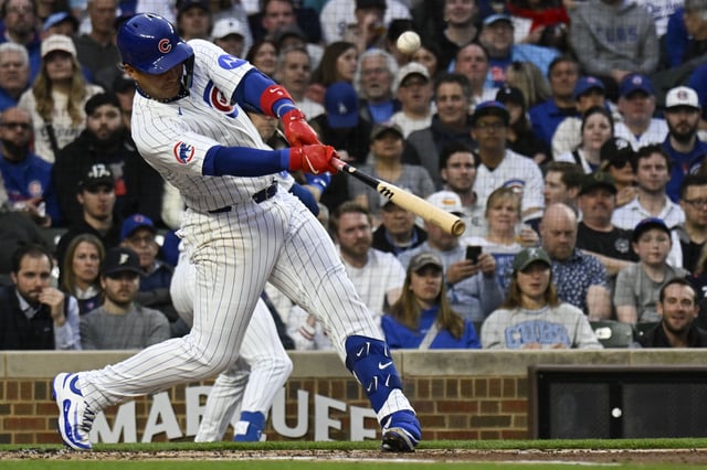 Apr 22, 2025; Chicago, Illinois, USA;  Chicago Cubs catcher Miguel Amaya (9)  hits an RBI single against the Los Angeles Dodgers during the first inning at Wrigley Field. Mandatory Credit: Matt Marton-Imagn Images