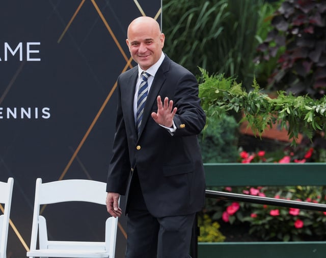 Tennis Hall of Famer Andre Agassi walks onto the stage as he is introduced during the International Tennis Hall of Fame ceremony in Newport, Rhode Island, U.S., July 20, 2024. REUTERS/Mark Stockwell