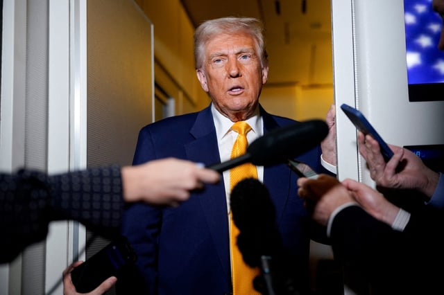 U.S. President Donald Trump speaks to the media on board Air Force One on the way to Miami, Florida, U.S., April 12, 2025. REUTERS/Nathan Howard/File Photo
