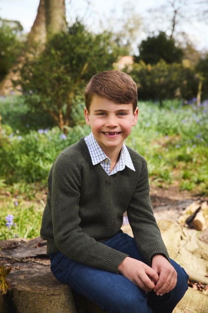 Prince Louis sits on a tree trunk as he poses for a portrait marking his seventh birthday, which he celebrated on April 23, 2025.