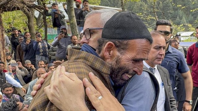 Jammu and Kashmir chief minister Omar Abdullah consoling the father of Syed Adil Hussain Shah, a pony ride operator who was killed in the terrorist attack in Pahalgam on Tuesday, in Anantnag district on Wednesday.