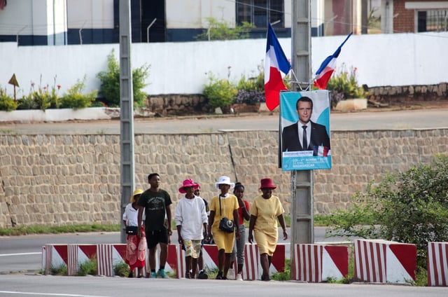 Residents wait for French President Emmanuel Macron to arrive in Antananarivo, Madagascar, Wednesday, April 23, 2025. (AP Photo/Alexander Joe)