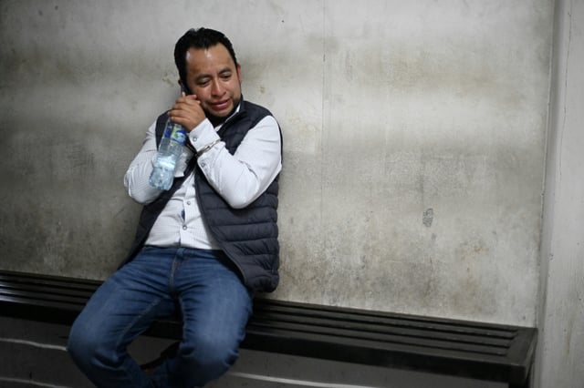 Guatemalan Energy and Mines Vice Minister Luis Pacheco talks by telephone at a courthouse following his arrest