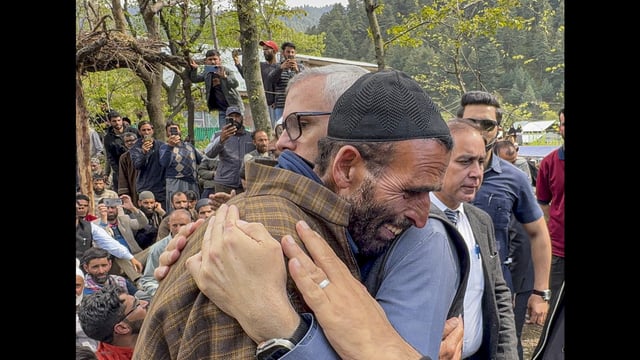 J&K Chief Minister Omar Abdullah consoles the father of Adil Hussain Shah, a pony ride operator who was killed in a terrorist attack in Pahalgam on Tuesday, in Anantnag district on Wednesday. (PTI)