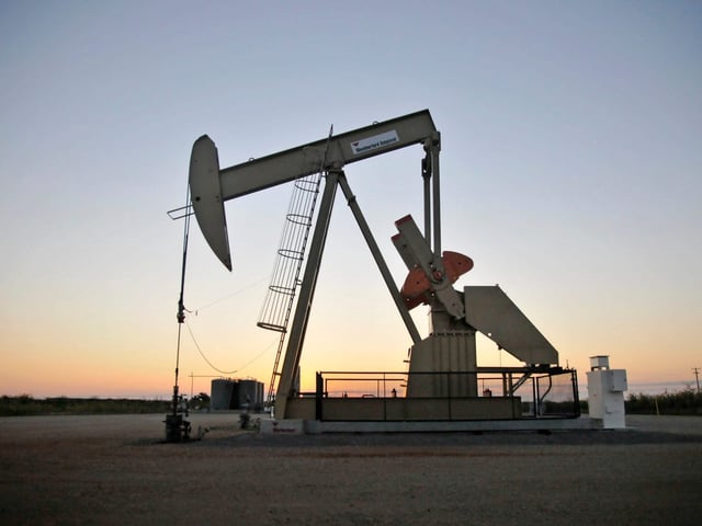 A pump jack operates at a well site leased by Devon Energy Production Company near Guthrie, Oklahoma September 15, 2015.