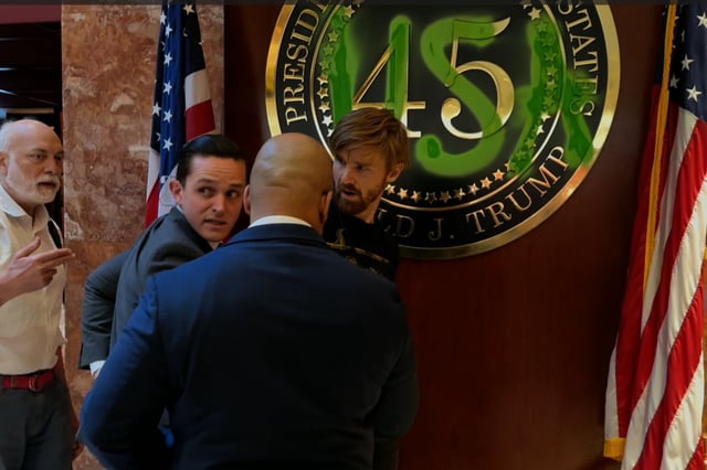 This is the moment a protester at Trump Tower was arrested after painting over the presidential seal.