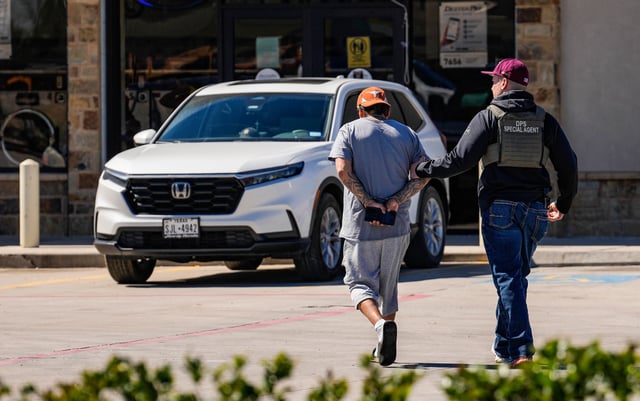 A man is detained by federal agents conducting immigration raids on Monday, Feb. 24, 2025 in Colony Ridge, Texas. (Raquel Natalicchio/Houston Chronicle via Getty Images)