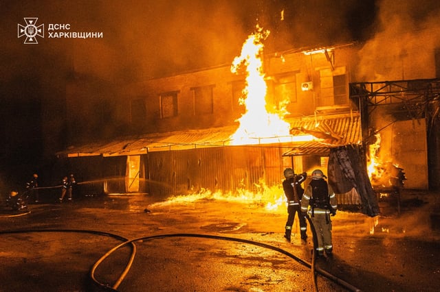 Firefighters at the site of a Russian attack in Kharkiv
