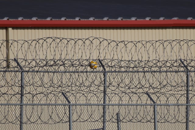 A ball lies stuck on the fencing at the Bluebonnet Detention Facility, where Venezuelans at the center of a Supreme Court ruling on deportation are held, in Anson, Texas, U.S. April 22, 2025. REUTERS/Daniel Cole/File Photo