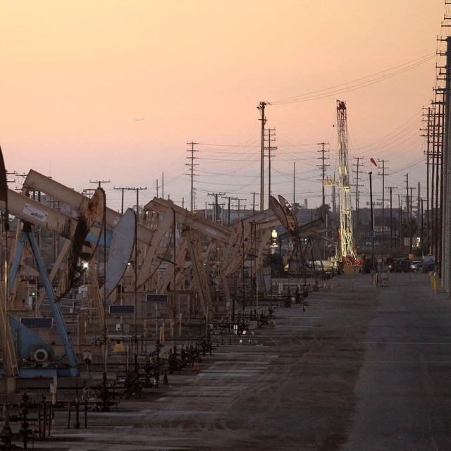 FILE PHOTO: Oil rig pumpjacks, also known as thirsty birds, extract crude from the Wilmington Field oil deposits area near Long Beach, California July 30, 2013.  REUTERS/David McNew//File Photo