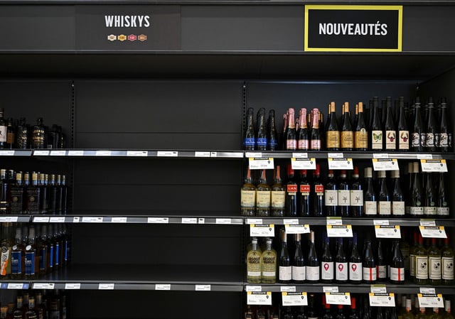 Empty space on a shelf where American-made liquor had been at a liquor store in Montreal, Canada.