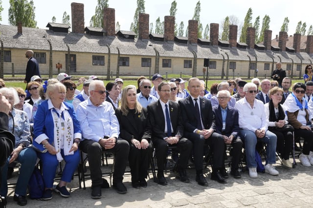 Poland's President Andrzej Duda, center right, and his Israel's counterpart Isaac Herzog, center left, meet with holocaust survivors at the former Nazi German death camp of Auschwitz-Birkenau before the "March of the Living", the annual Holocaust remembrance event in memory of the six million Holocaust victims in Oswiecim, Poland, Thursday, April 24, 2025. (AP Photo/Czarek Sokolowski)