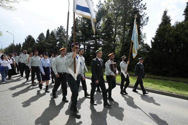 People attend the "March of the Living", the annual Holocaust remembrance event in memory of the six million Holocaust victims, at the former Nazi German death camp of Auschwitz-Birkenau in Oswiecim, Poland, Thursday, April 24, 2025. (AP Photo/Czarek Sokolowski)