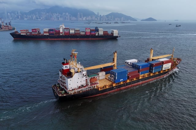 Vessels carrying shipping containers sail near Kwai Tsing Container Terminal in Hong Kong, China, April 23, 2025. REUTERS/Tyrone Siu