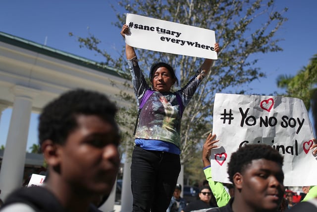 Lucia Quiej joins with demonstrators to rally in front of Homestead City Hall in Homestead, Fla., on Nov. 16, 2016