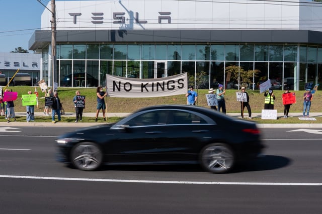Nearly 50 people gathered on the sidewalk along Tennessee Street in front of the Tesla dealership as part of the “Tallahassee Tesla Takedown” protest on Thursday, April 10, 2025.