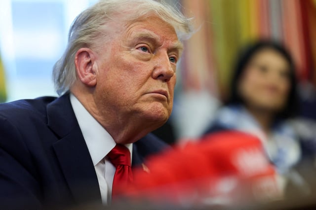 U.S. President Donald Trump looks on, as he signs executive orders in the Oval Office at the White House in Washington, D.C., U.S., April 23, 2025. REUTERS/Leah Millis/File Photo