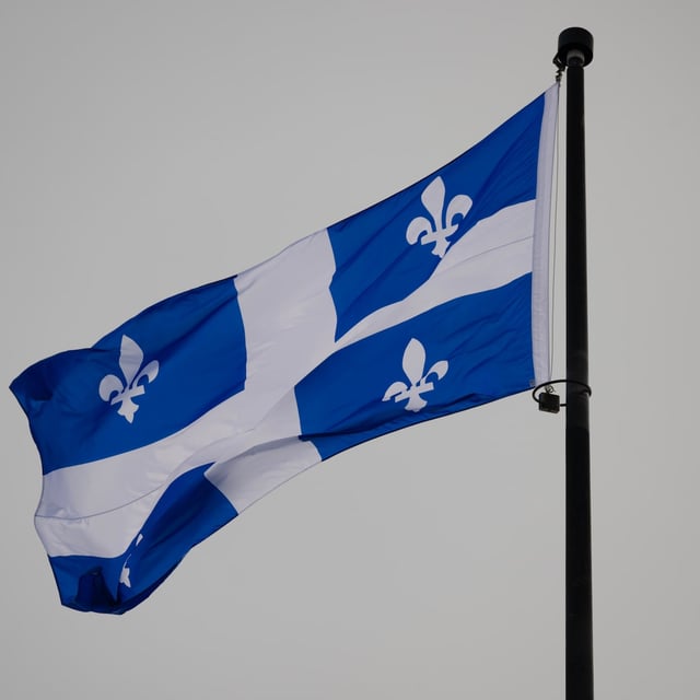 The Quebec Fleur-de-lis provincial flag flies on top of the National Assembly’s main tower, January 18, 2023 in Quebec City. THE CANADIAN PRESS/Jacques Boissinot