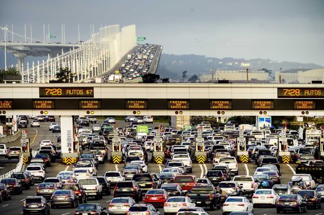 Cars and trucks approach the Bay Bridge toll plaza in Oakland. For the first time in nearly half a century, the California Department of Motor Vehicles is preparing to roll out a new alphanumeric configuration for standard passenger vehicle plates, a quiet but striking milestone in the state’s automotive history.