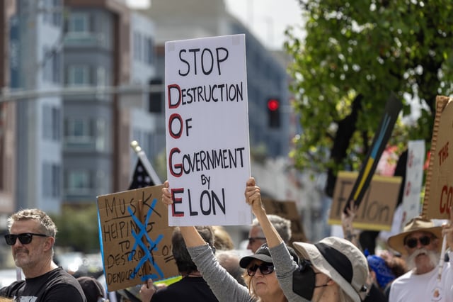HAWTHORNE, CALIFORNIA - MARCH 01: People protest outside the former SpaceX Headquarters to denounce the chaos caused by massive government slashing efforts by SpaceX CEO Elon Musk, working as a &#34;special government employee&#34; of the Trump administration, and his Department of Government Efficiency (DOGE) on March 1, 2025 in Hawthorne, California. Musk moved SpaceX headquarters from Hawthorne to its new location at Boca Chica Beach, near Brownsville, Texas, in 2024. (Photo by David McNew/Getty Images)