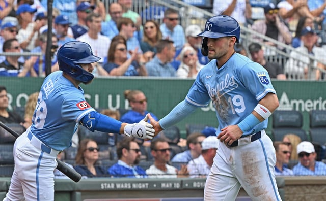 Apr 24, 2025; Kansas City, Missouri, USA;  Kansas City Royals second baseman Michael Massey (19) shakes hands with teammate Kyle Isbel (28) after scoring a run in the third inning at Kauffman Stadium. Mandatory Credit: Peter Aiken-Imagn Images
