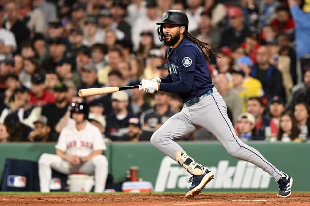 Apr 23, 2025; Boston, Massachusetts, USA; Seattle Mariners shortstop J.P. Crawford (3) watches the ball after hitting a RBI single against the Boston Red Sox during the seventh inning at Fenway Park. Mandatory Credit: Brian Fluharty-Imagn Images