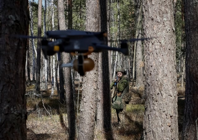 A young recruit of the 28th Knights of the Winter Campaign Separate Mechanised Brigade of the Ukrainian Armed Forces hides from a drone during an exercise, amid Russia's attack on Ukraine, in Kyiv region, Ukraine April 4, 2025. Ukraine's Defence Ministry launched a recruitment drive for young people, 18 to 24-year-olds, to serve in the military for a year for the equivalent of about $24,000 and hefty bonuses. REUTERS/Gleb Garanich