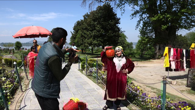 A tourists getting clicked at Nishat Garden in Srinagar on Thursday. (Waseem Andrabi /HT)